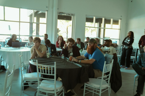 Retreat participants watching a presenter.